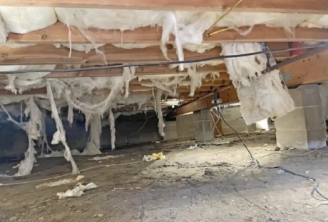 Crawl space before encapsulation showing moisture, exposed dirt, and potential mold growth in a Chattanooga home
